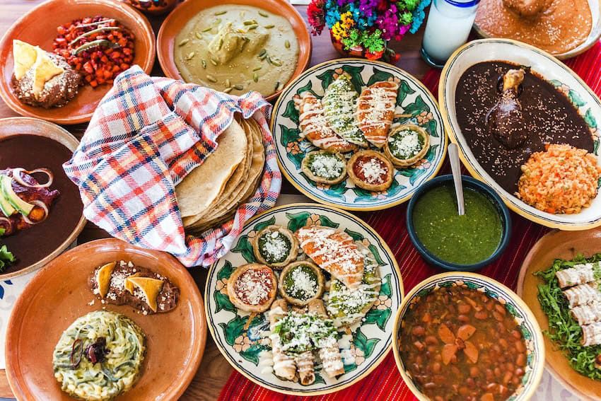 Table of traditional Oaxacan dishes: moles, tlayudas, memelas and more